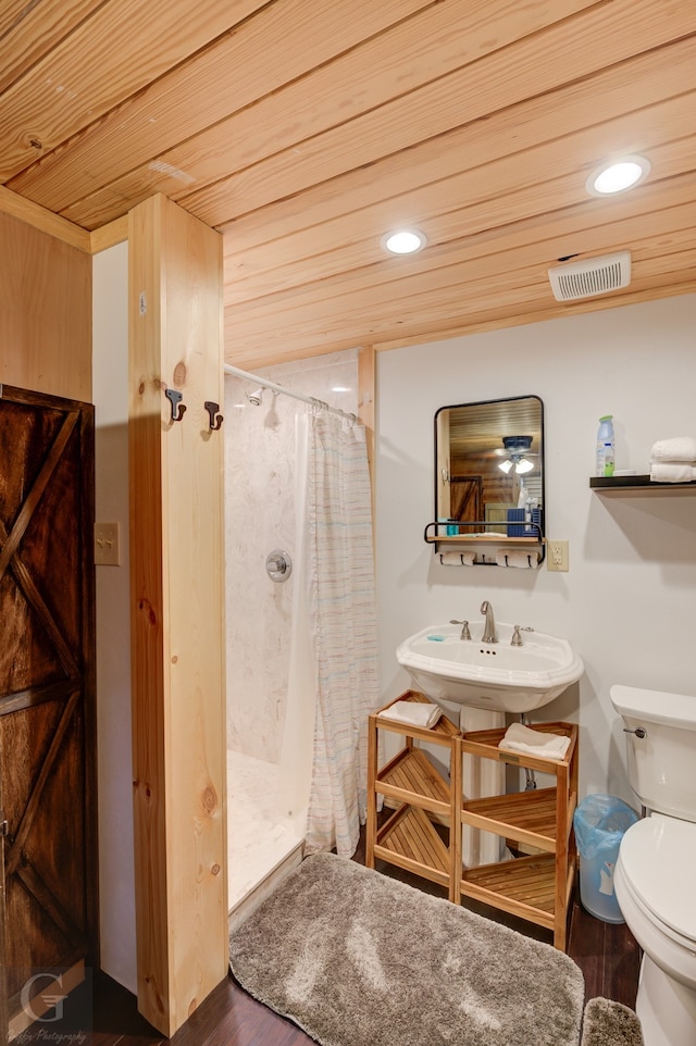 bathroom featuring hardwood / wood-style floors, curtained shower, toilet, and wood ceiling