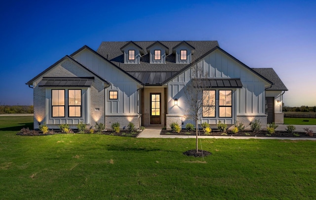 modern farmhouse with a lawn