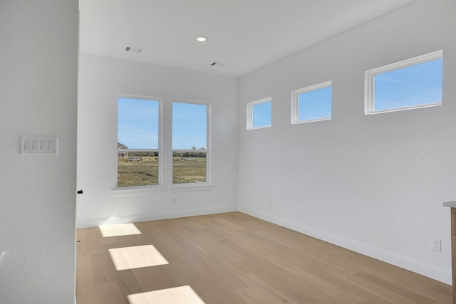 spare room with light hardwood / wood-style floors