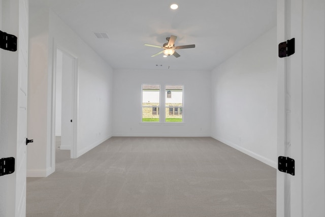 carpeted spare room with ceiling fan