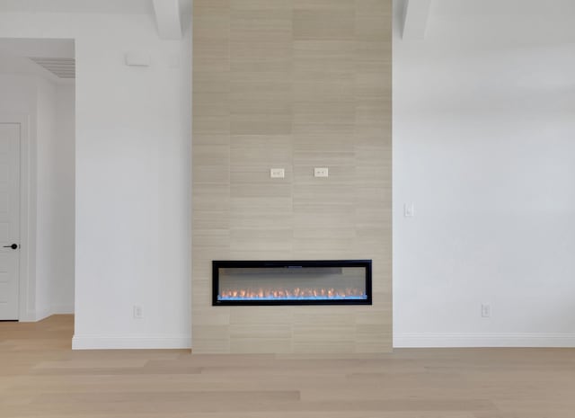 details with a fireplace and hardwood / wood-style flooring