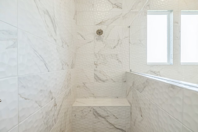 bathroom with tiled shower