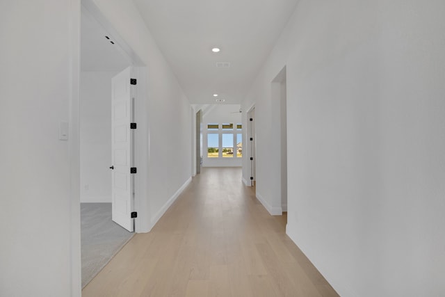 corridor with light hardwood / wood-style floors