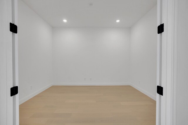 unfurnished bedroom with ceiling fan, light colored carpet, and ensuite bath