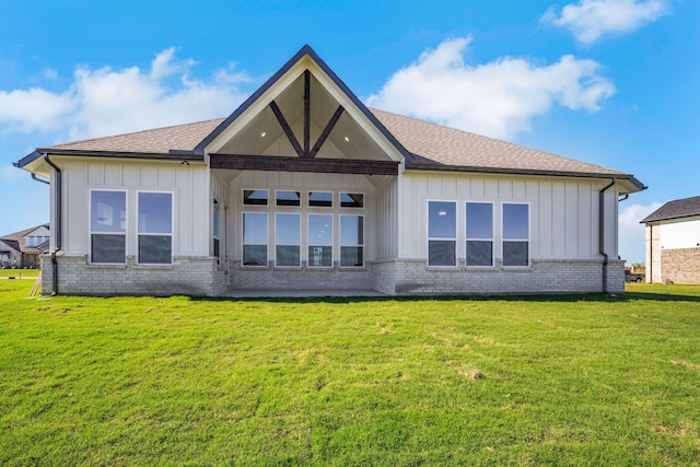 rear view of property with a lawn