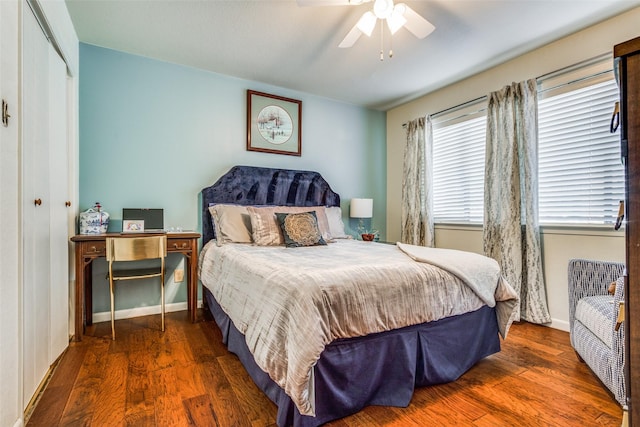 bedroom with ceiling fan, dark hardwood / wood-style floors, and a closet