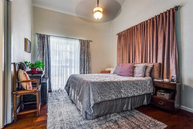 bedroom featuring dark hardwood / wood-style flooring and ceiling fan