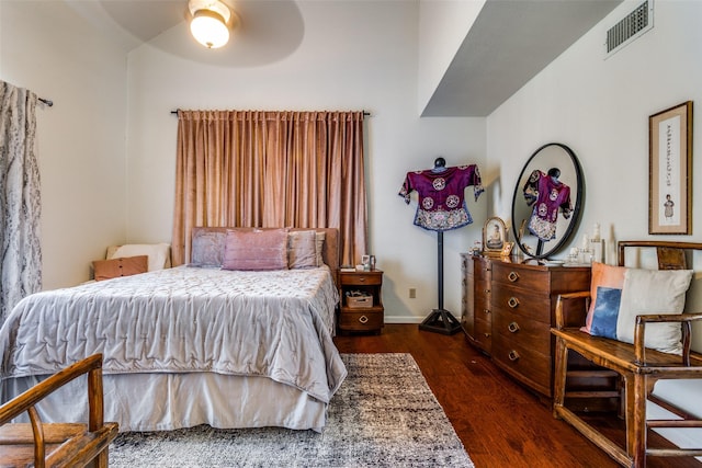 bedroom with dark hardwood / wood-style flooring and ceiling fan