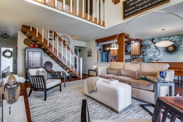 living room with a high ceiling and light hardwood / wood-style floors