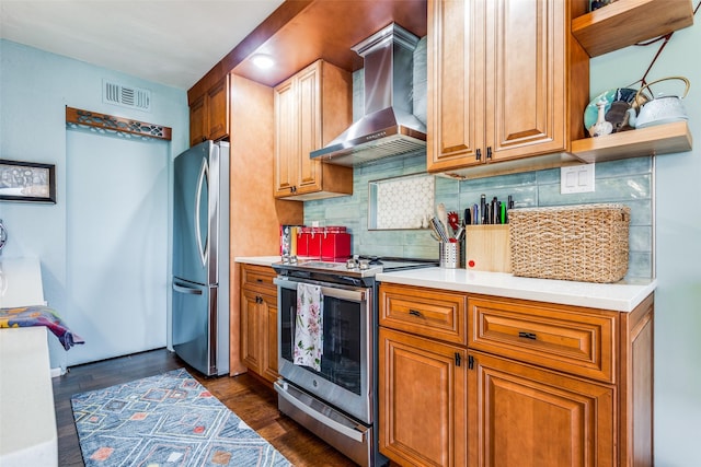 kitchen with wall chimney exhaust hood, dark hardwood / wood-style flooring, appliances with stainless steel finishes, and tasteful backsplash