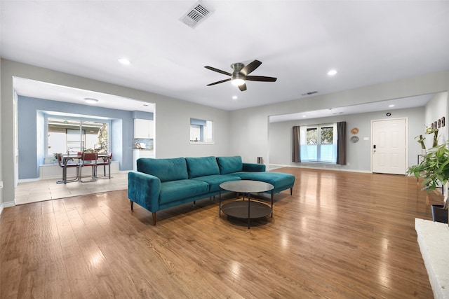 living room featuring hardwood / wood-style floors and ceiling fan