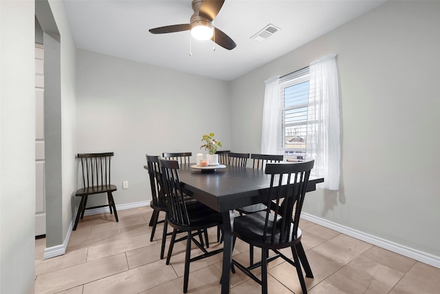 tiled dining area with ceiling fan