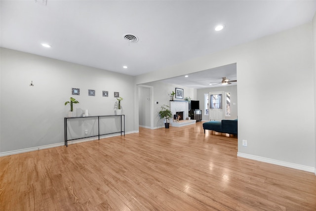 living room with ceiling fan and light hardwood / wood-style floors