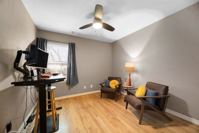 sitting room with ceiling fan and light wood-type flooring