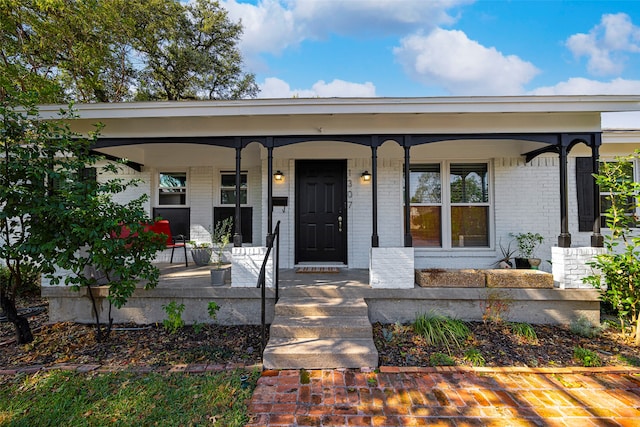 doorway to property featuring covered porch