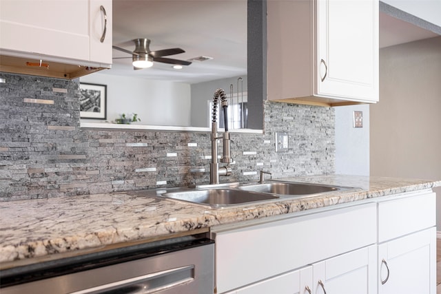 kitchen featuring sink, decorative backsplash, light stone countertops, white cabinets, and dishwasher