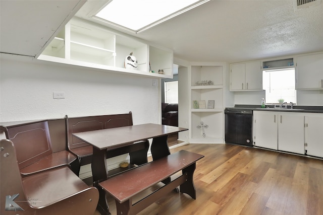 interior space featuring light hardwood / wood-style floors, a textured ceiling, and sink