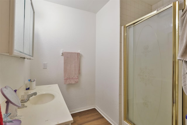 bathroom featuring vanity, an enclosed shower, and hardwood / wood-style flooring