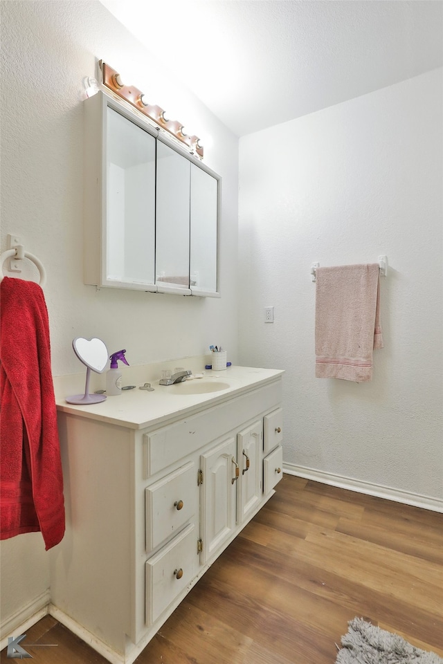 bathroom with vanity and wood-type flooring