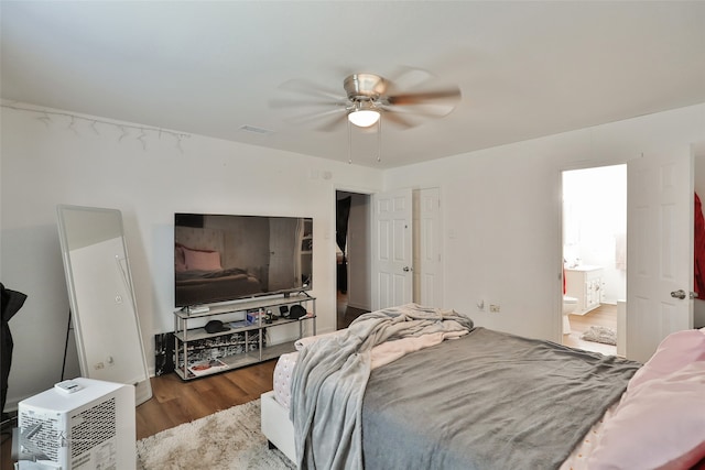 bedroom featuring hardwood / wood-style flooring, ceiling fan, and connected bathroom