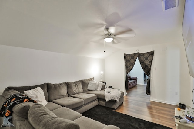 living room featuring hardwood / wood-style floors, ceiling fan, and vaulted ceiling