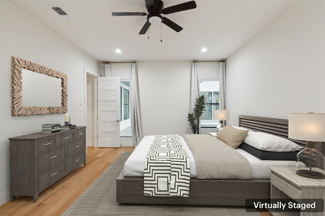 bedroom with light hardwood / wood-style floors and ceiling fan