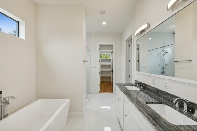 bathroom with plenty of natural light, shower with separate bathtub, tile patterned floors, and vanity