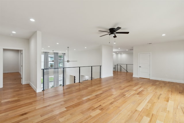 empty room with light hardwood / wood-style floors and ceiling fan