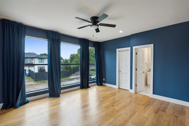 unfurnished room featuring light hardwood / wood-style floors and ceiling fan