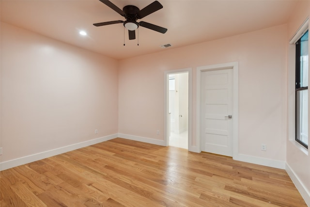 unfurnished room with light wood-type flooring, a wealth of natural light, and ceiling fan