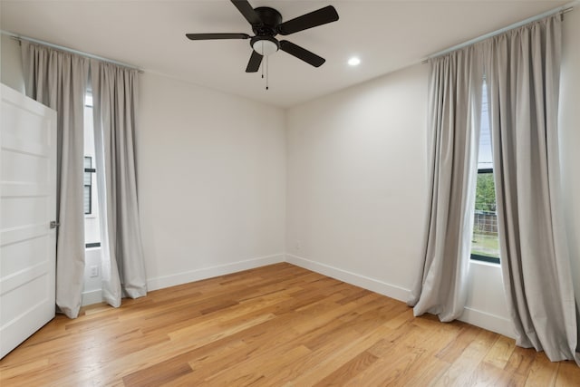 empty room with light hardwood / wood-style floors and ceiling fan