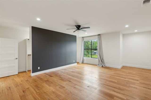 unfurnished room with ceiling fan and light hardwood / wood-style floors