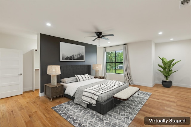 bedroom with ceiling fan and light hardwood / wood-style flooring