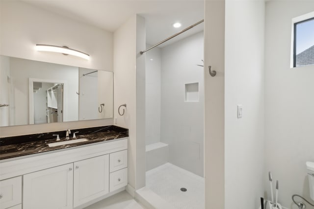 bathroom with a shower and vanity