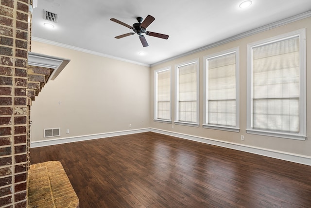 spare room featuring plenty of natural light, wood-type flooring, and crown molding