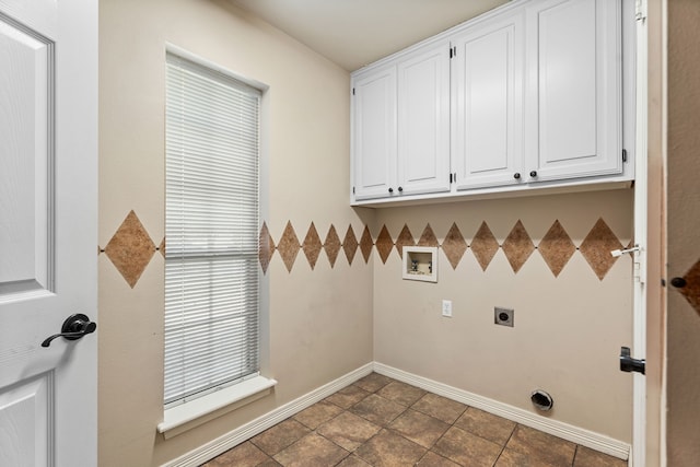 washroom with cabinets, washer hookup, electric dryer hookup, and dark tile patterned flooring