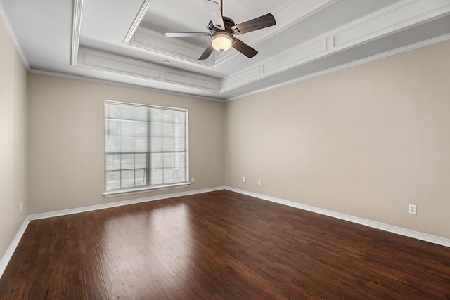 empty room featuring ornamental molding, wood-type flooring, ceiling fan, and a tray ceiling