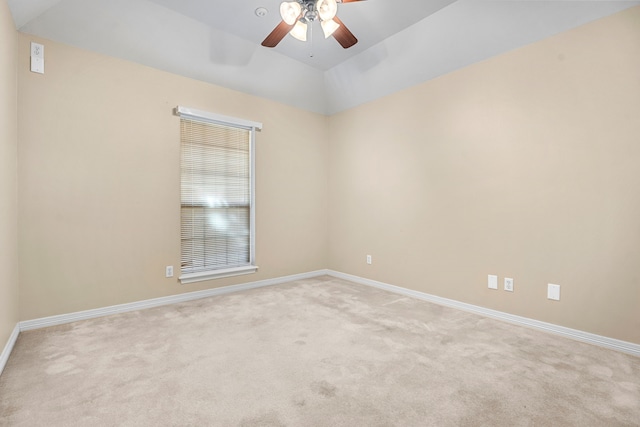 carpeted spare room featuring lofted ceiling and ceiling fan