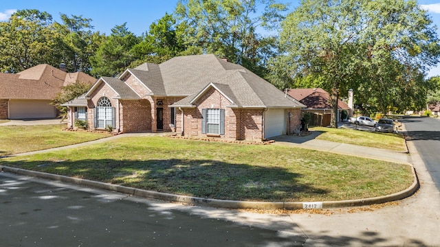 view of front of home with a garage and a front lawn