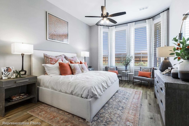 bedroom with ceiling fan and wood-type flooring