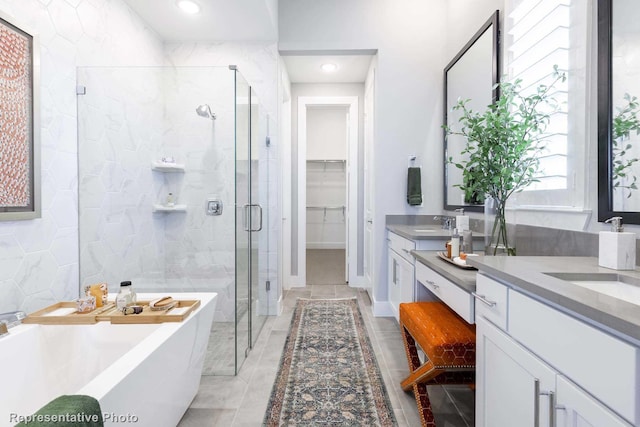 bathroom featuring tile patterned flooring, vanity, and separate shower and tub