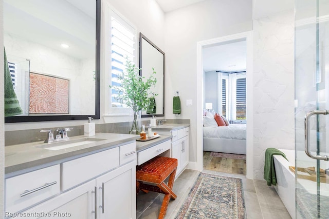 bathroom with an enclosed shower, hardwood / wood-style flooring, and a healthy amount of sunlight