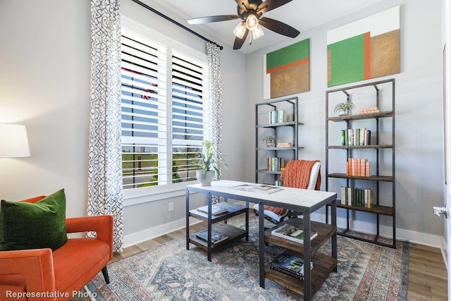 home office featuring hardwood / wood-style floors and ceiling fan