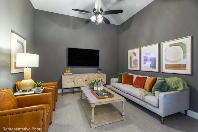 carpeted living room with high vaulted ceiling and ceiling fan