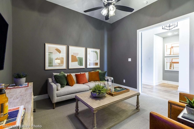 living room featuring ceiling fan and light wood-type flooring