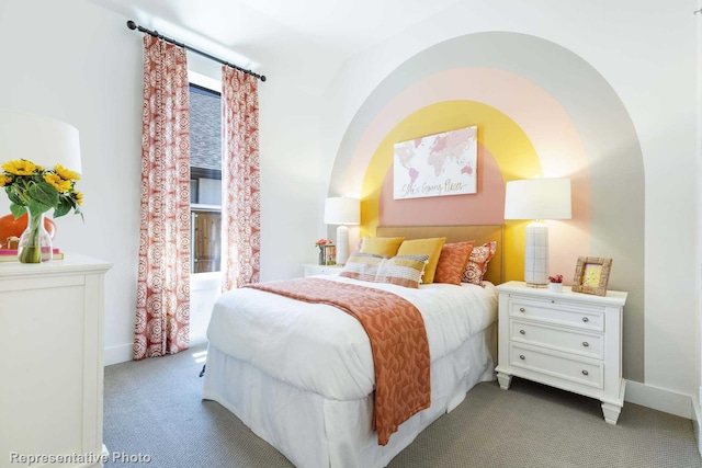 bedroom featuring lofted ceiling and light carpet