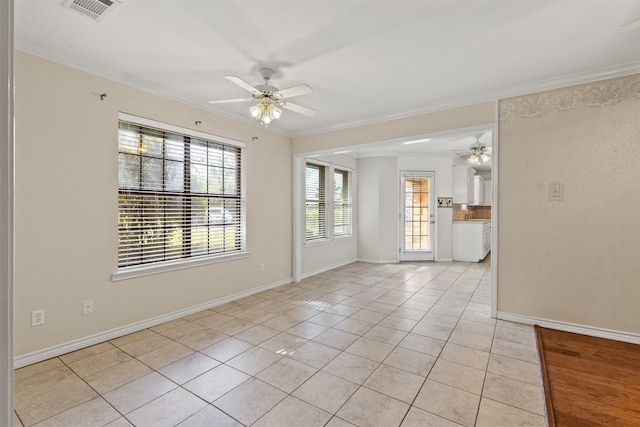 empty room featuring a wealth of natural light and crown molding