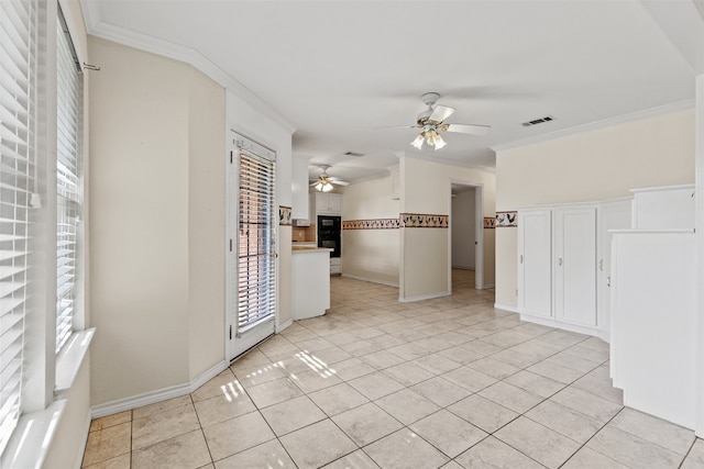 tiled spare room with ceiling fan, a healthy amount of sunlight, and crown molding