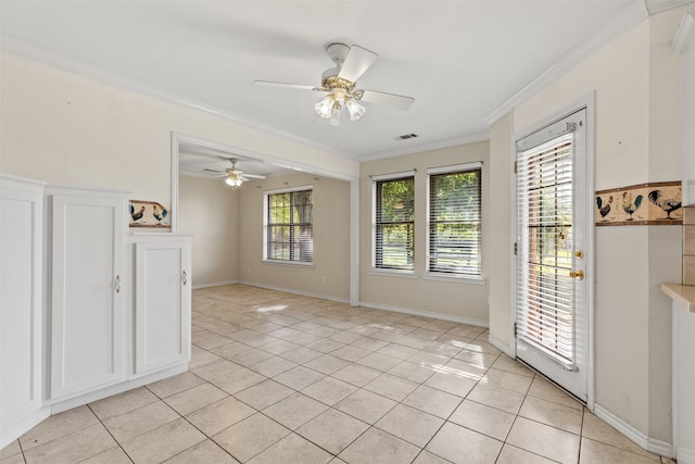 tiled spare room featuring ceiling fan and crown molding