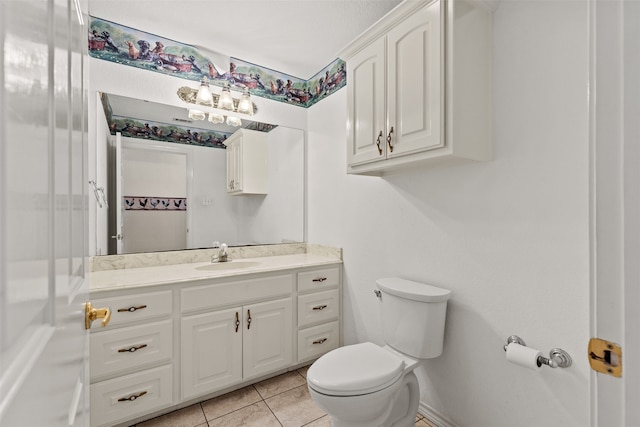 bathroom featuring vanity, tile patterned flooring, and toilet